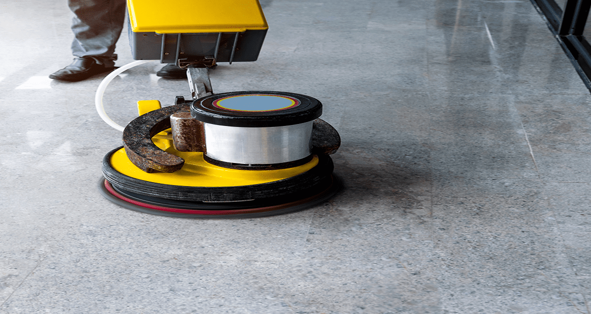 Floor polishing machine on shiny marble surface.